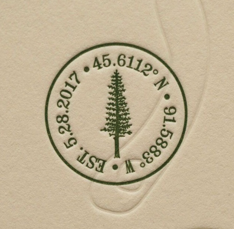 Pressed stamp with tree, date and coordinates