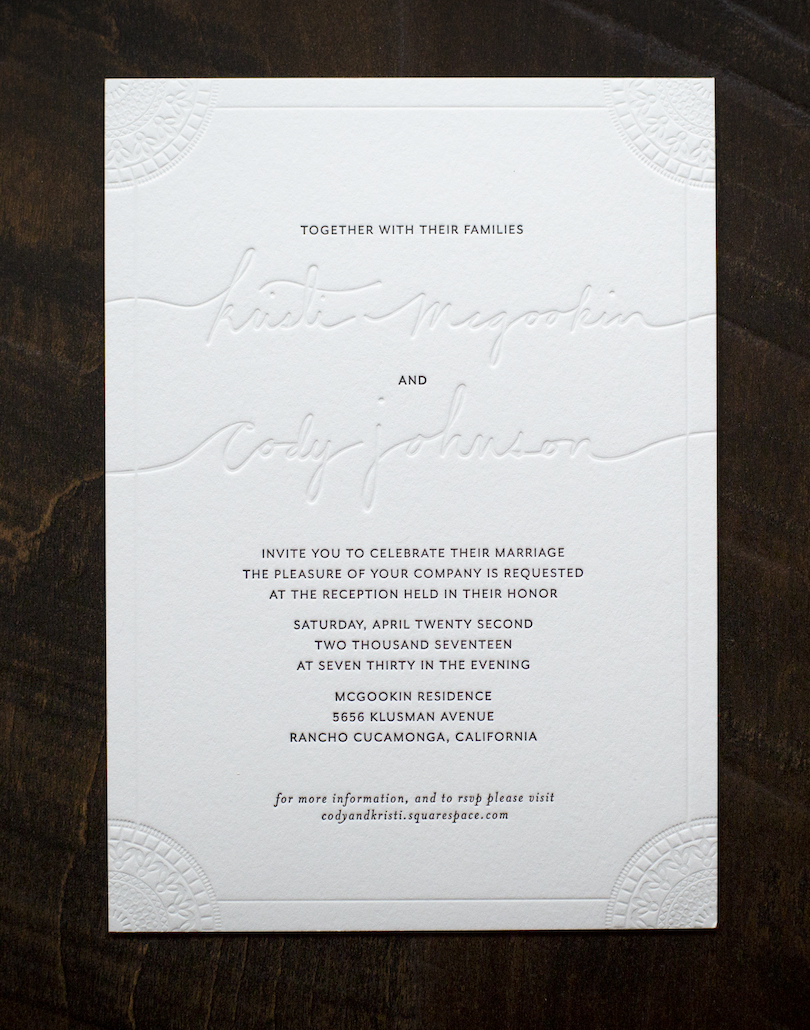 A letterpress printed wedding invitation with black ink and bling deboss.