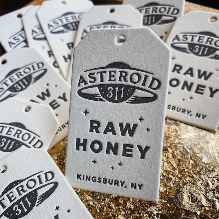 A letterpress printed hang tag for a raw honey product