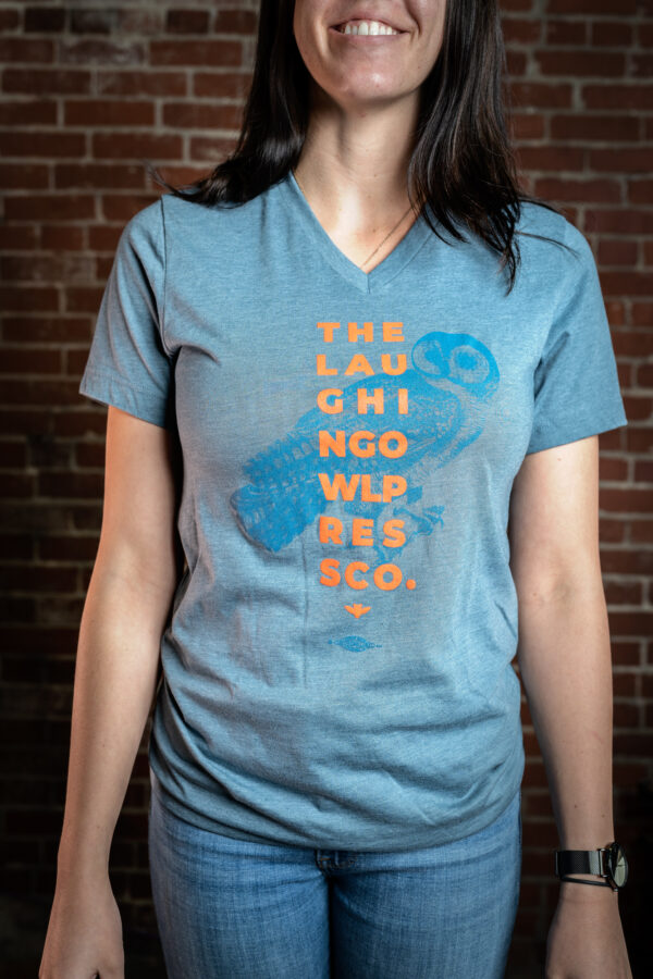 Woman wearing a blue shit with orange printing