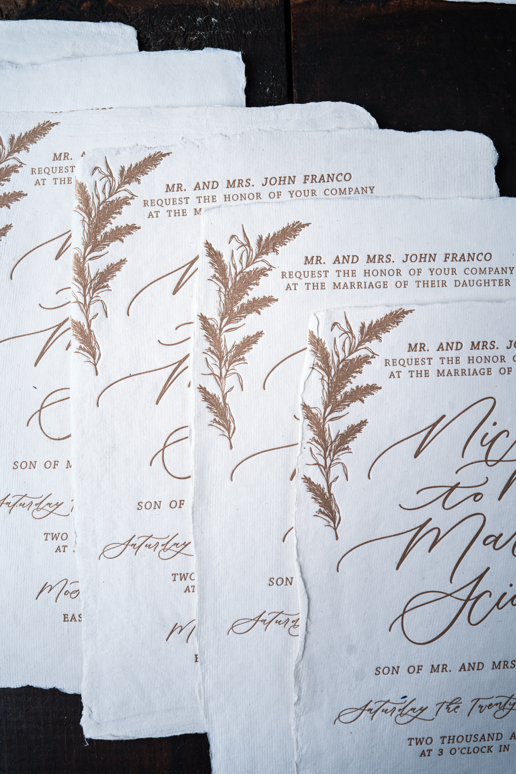 A letterpress printed invitation on handmade paper showing variations in image registration. 