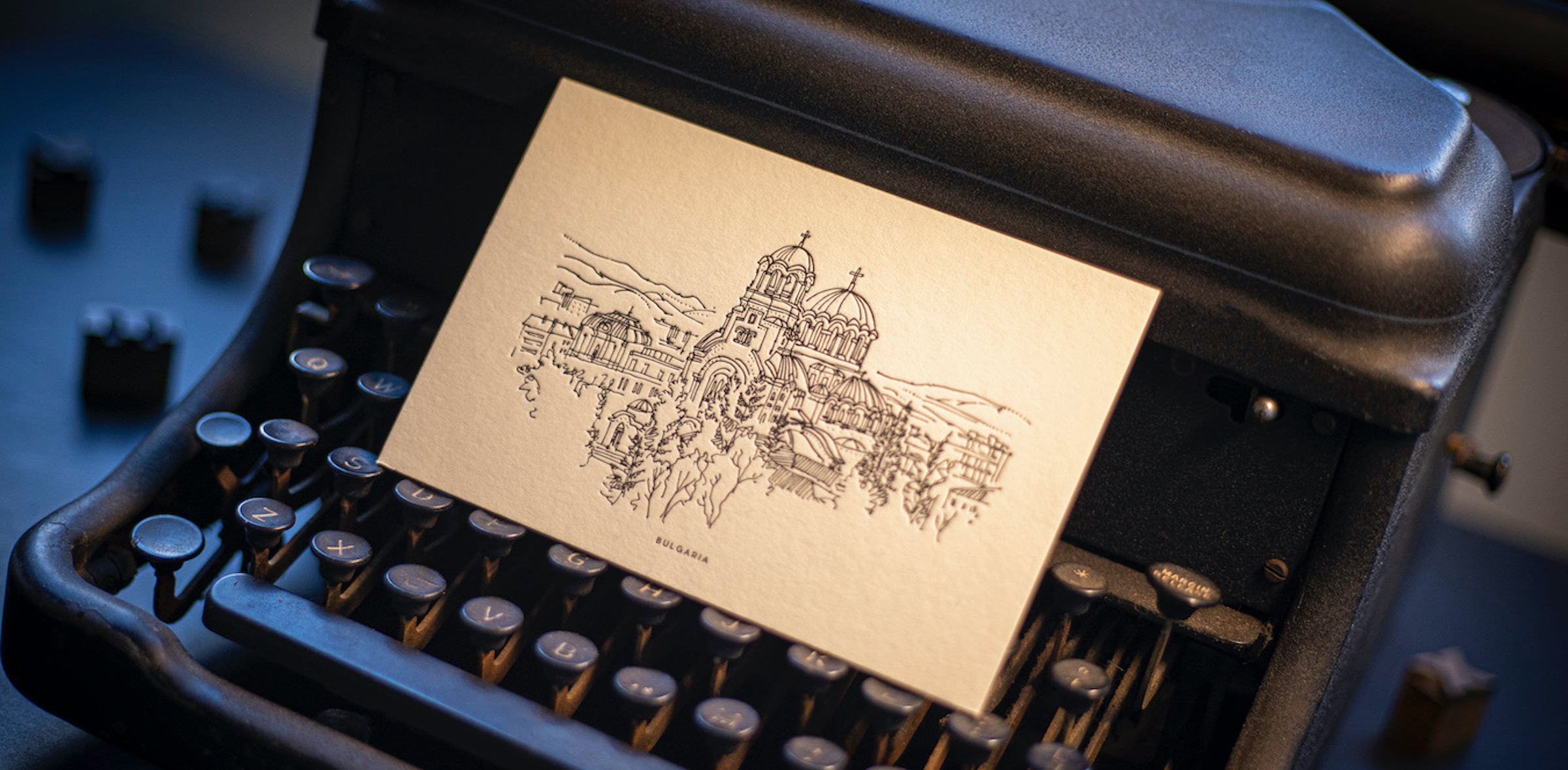 A flat card with a letterpress printed image of a city skyline.