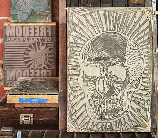 A hand carved linoleum block of a skull. 