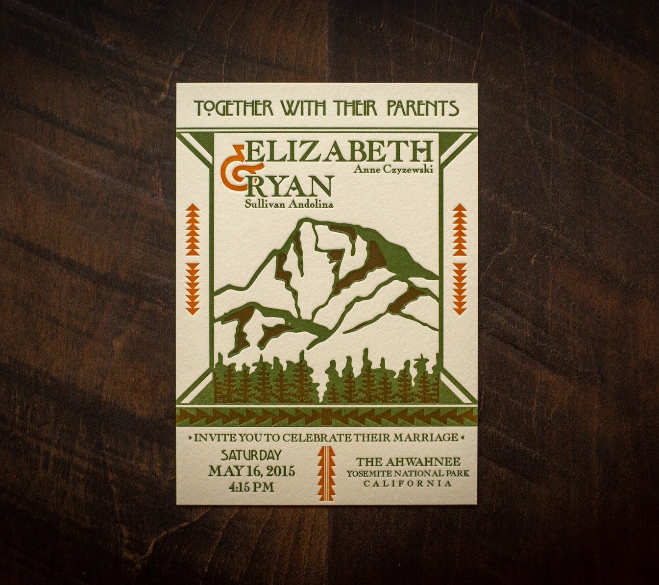 A letterpress printed wedding invitation with orange and green ink on Lettra ecru paper.